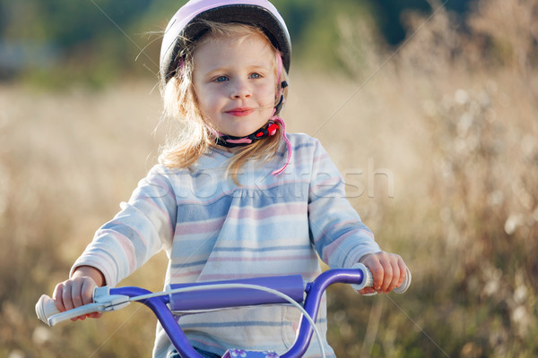 Small funny kid riding bike with training wheels. Stock photo © luckyraccoon