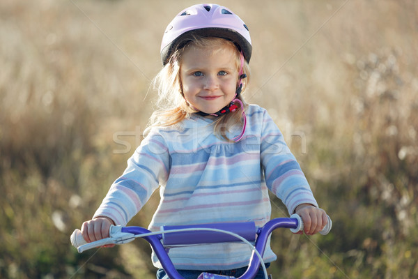 Small funny kid riding bike with training wheels. Stock photo © luckyraccoon