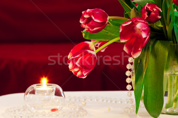 Bunch of tulips with candle - indoor shot Stock photo © luckyraccoon