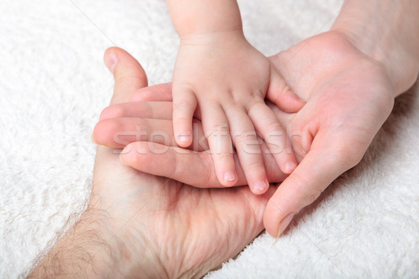 Closeup of baby, mother and father hands Stock photo © luckyraccoon