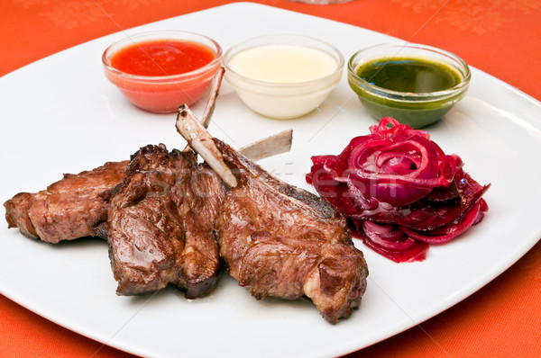 Closeup of a grilled lamb ribs with beet-root carpaccio Stock photo © luckyraccoon