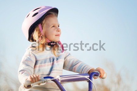 Small funny kid riding bike with training wheels. Stock photo © luckyraccoon