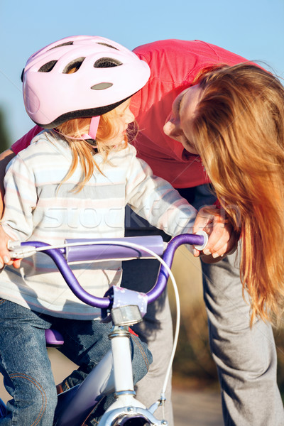 Redhead girl in helmet learning riding bike. Stock photo © luckyraccoon