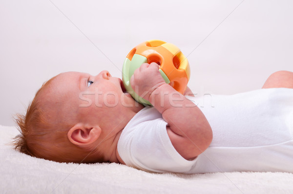 Small laying baby with toy Stock photo © luckyraccoon