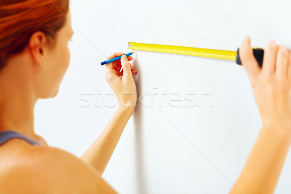 Portrait of young woman with measuring tape. Stock photo © luckyraccoon