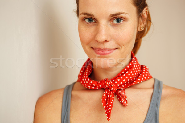 Portrait of young woman standing against wall. Stock photo © luckyraccoon