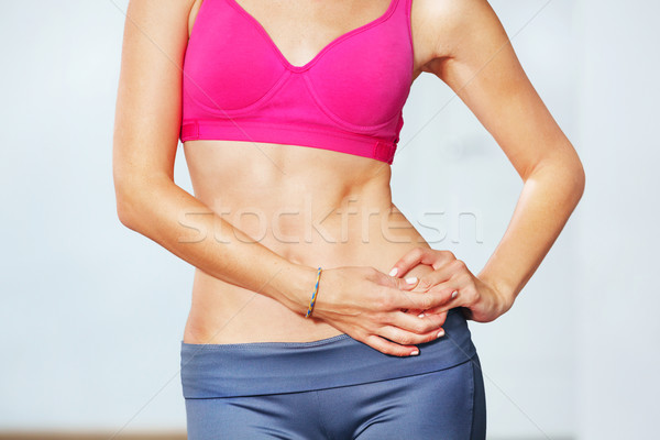 Closeup of young slim woman with six-pack torso. Stock photo © luckyraccoon