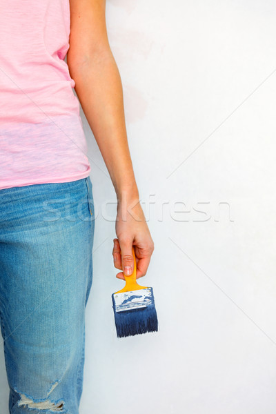 Woman standing with paint and brush ready to work Stock photo © luckyraccoon