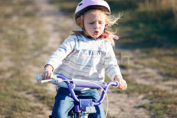 Small funny kid riding bike with training wheels. Stock photo © luckyraccoon