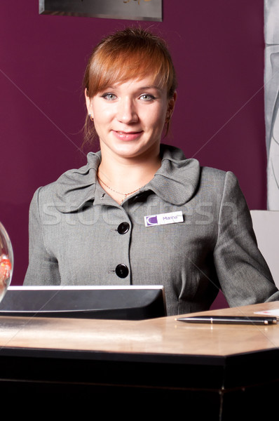 Receptionist reception desk giovani donna sorridente donne Foto d'archivio © luckyraccoon