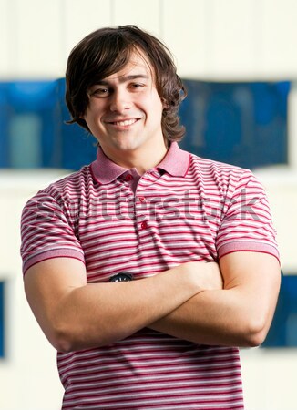 Stock photo: Portait of a young man standing with his hands in pocket 