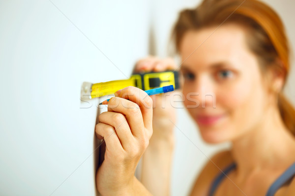 Portrait of young woman with measuring tape. Stock photo © luckyraccoon