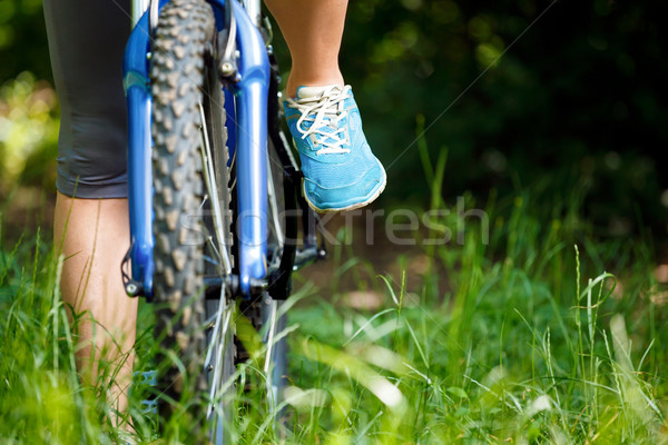 Closeup of woman riding mountain bike outdoors. Stock photo © luckyraccoon