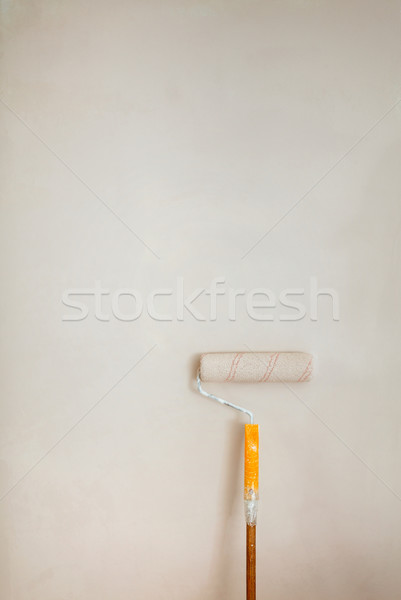 Roller brush with orange grip against wall. Stock photo © luckyraccoon