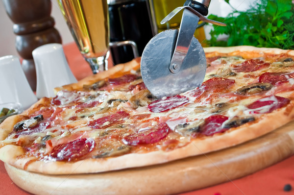 Closeup of a pizza with salami and mushrooms Stock photo © luckyraccoon