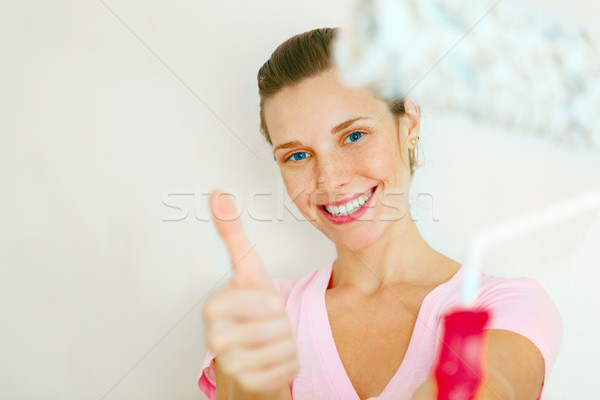 Happy Woman showing thumb up with roller brush. Stock photo © luckyraccoon