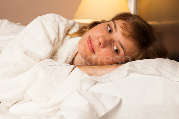 Young woman wearing a white robe Stock photo © luckyraccoon