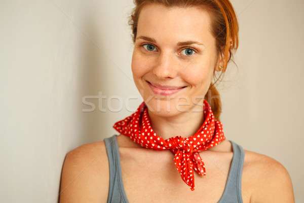 Portrait of young woman standing against wall. Stock photo © luckyraccoon