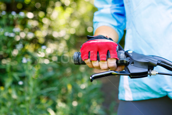 Stock photo: Closeup of hands in red protective gloves holding handlebar.