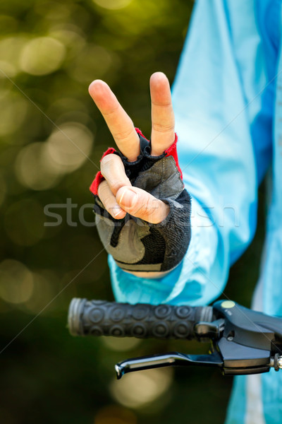 Biker showing victory sign - cycling concept image Stock photo © luckyraccoon