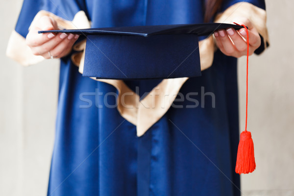 Young student holding academic hat in hands Stock photo © luckyraccoon