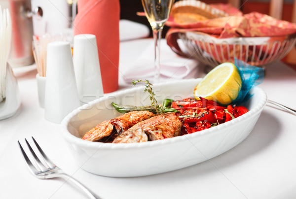 Fried fish with red peppers and lemon. Stock photo © luckyraccoon