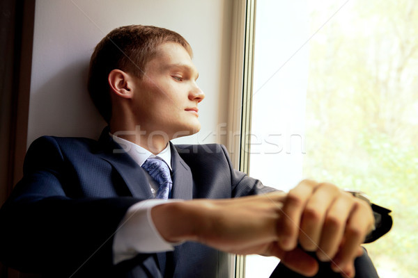 Young man sitting on windowsill waiting bride Stock photo © luckyraccoon