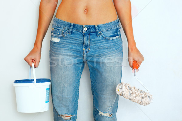 Woman standing with paint and brush ready to work Stock photo © luckyraccoon