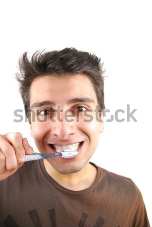 Stock photo: Cute guy washing his teeth
