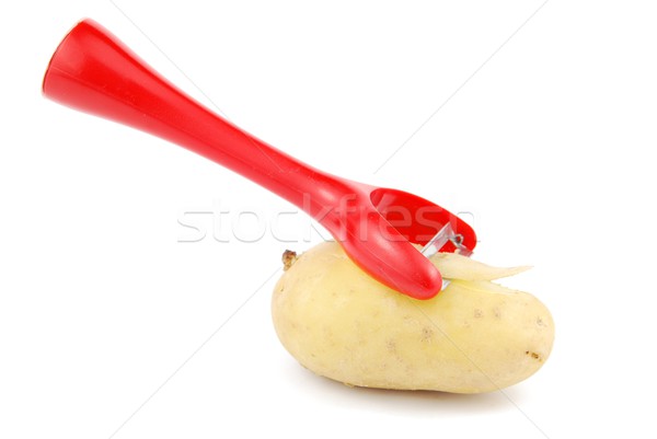 Stock photo: Peeling a potato with peeler on white