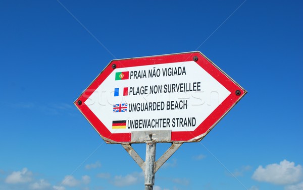 Sign at the beach (unguarded beach) against blue sky Stock photo © luissantos84