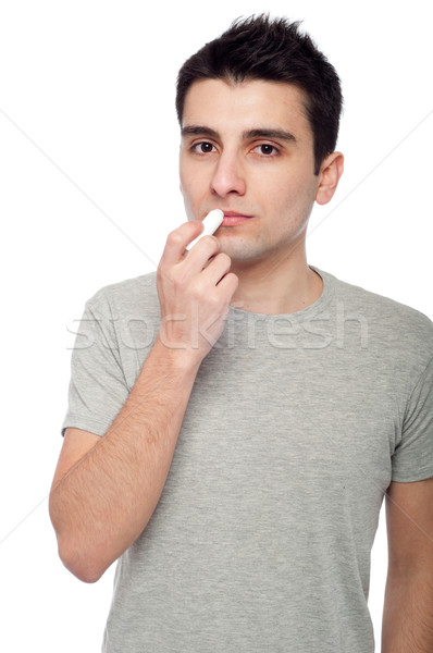 молодым человеком губа бальзам красивый изолированный Сток-фото © luissantos84