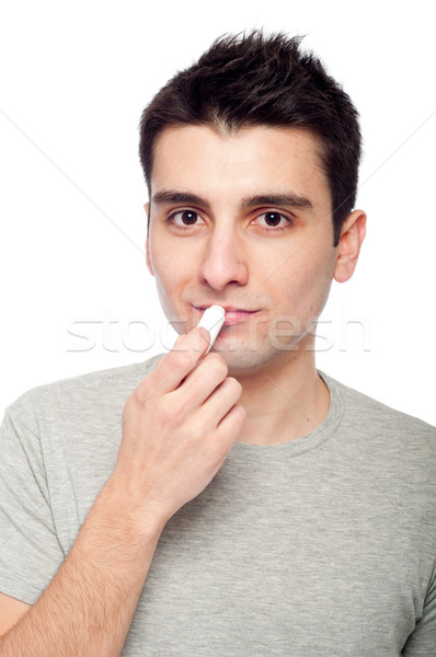 Jeune homme lèvre baume élégant isolé [[stock_photo]] © luissantos84