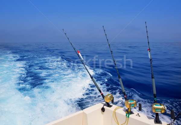 boat fishing trolling in deep blue ocean offshore Stock photo © lunamarina