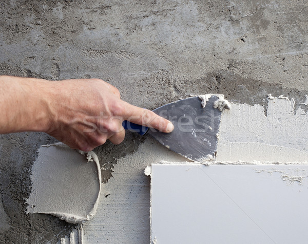 construction spatula trowel in tile work with mortar Stock photo © lunamarina