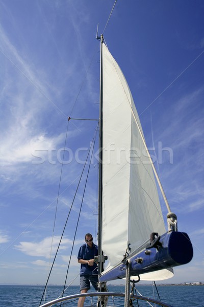 Sailor in sailboat rigging the sails Stock photo © lunamarina