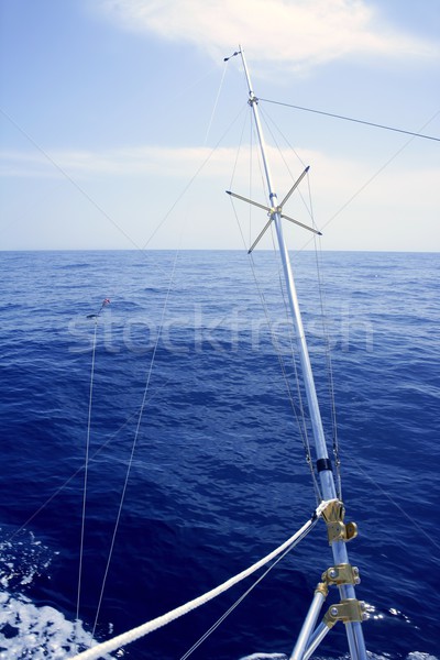 Blue sea with outrigger fishing boat equipment Stock photo © lunamarina