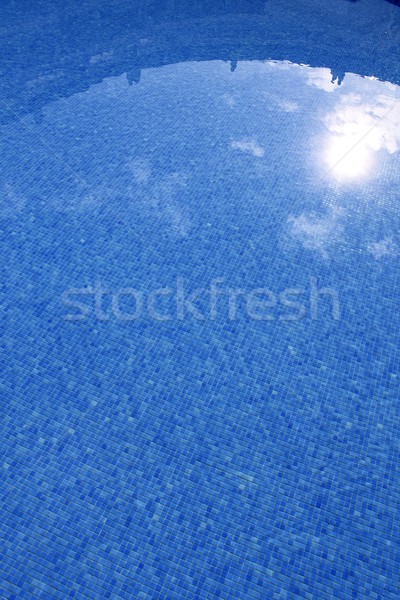 blue tiled swimming pool with sun reflexion Stock photo © lunamarina