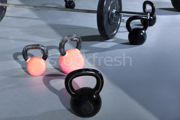 Stock photo: Kettlebells at crossfit gym with lifting bar