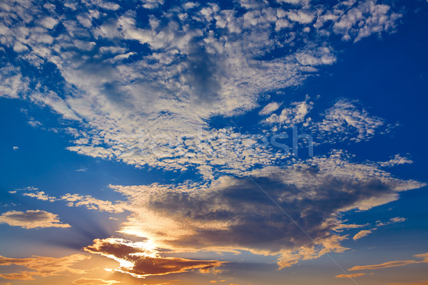 Stock photo: Sunset sky with golden and blue clouds