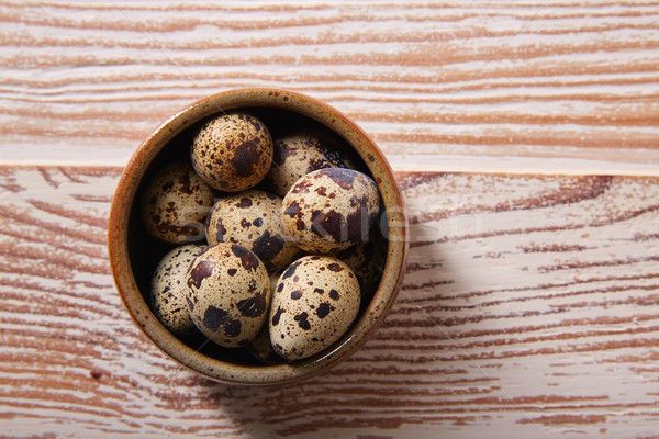 Quail eggs in a little bowl with nest shape Stock photo © lunamarina