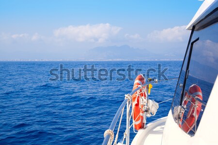 Boat rail with round orange lifesaver blue sea  Stock photo © lunamarina