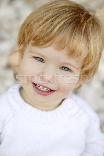 Szőke fiú mosolyog kövek portré arc Stock fotó © lunamarina