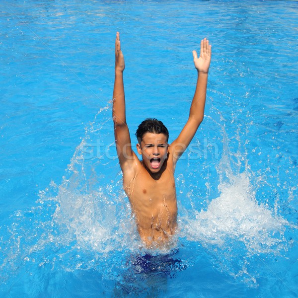 boy teenager splashing water open arms pool Stock photo © lunamarina
