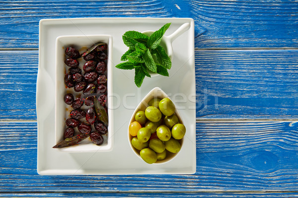 Stock photo: Mediterranean pickles black olives and mint leaves