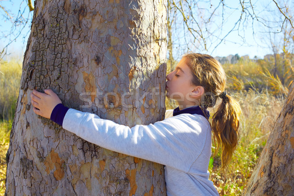 Kid girls loves nature kissing a tree tunk Stock photo © lunamarina