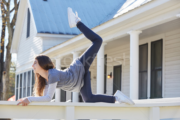 Tween kid girl training gymnastics on a fence Stock photo © lunamarina