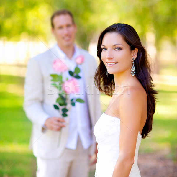 couple just married with man holding flowers Stock photo © lunamarina