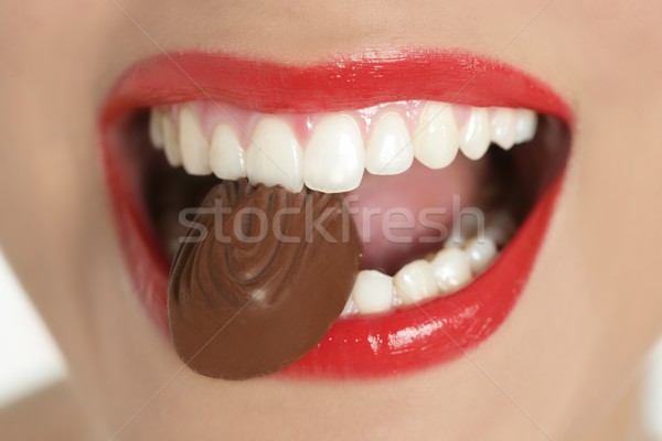 Chocolate sweet in beautiful woman mouth Stock photo © lunamarina