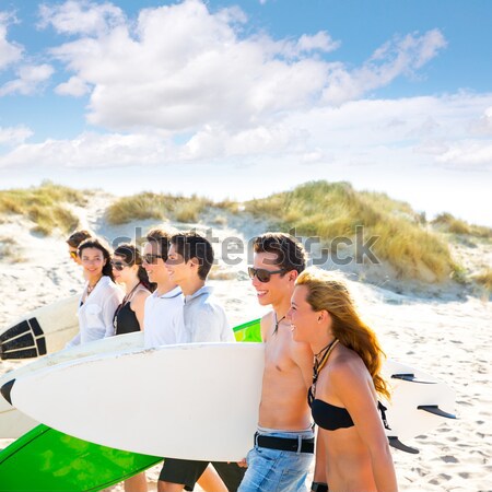 Surfer teen boys walking at beach shore Stock photo © lunamarina